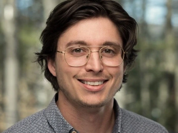Headshot image of graduate student outside.