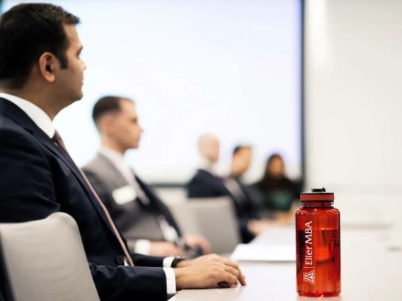 Students wearing business formal attire sitting in a classroom.