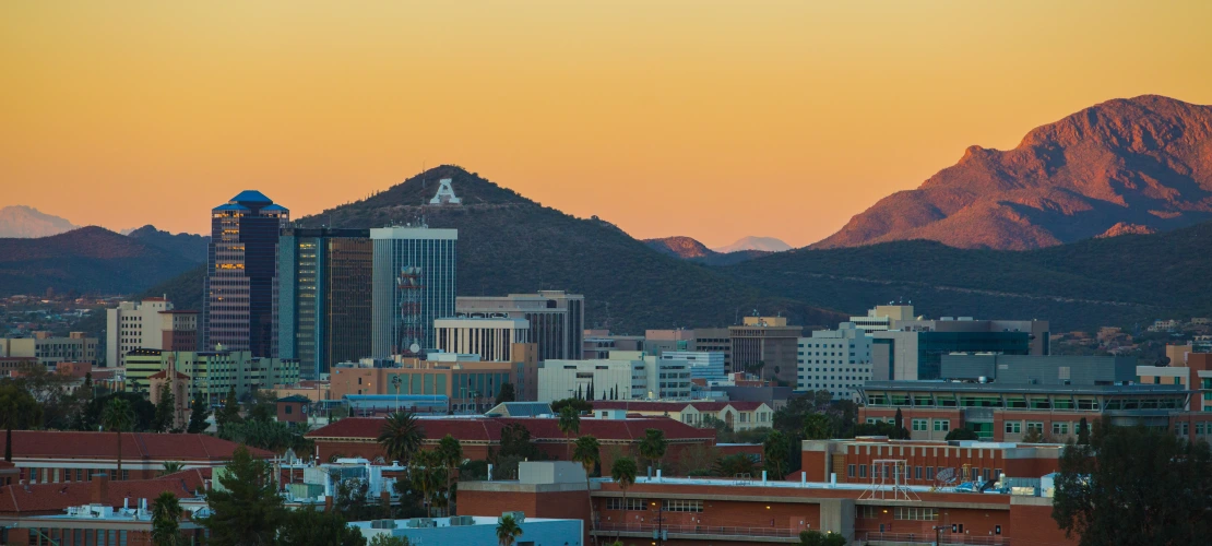  Landscape image of campus featuring A Mountain in the background, glowing in the vibrant colors of an Arizona sunset.