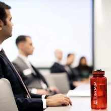 Students wearing business formal attire sitting in a classroom.