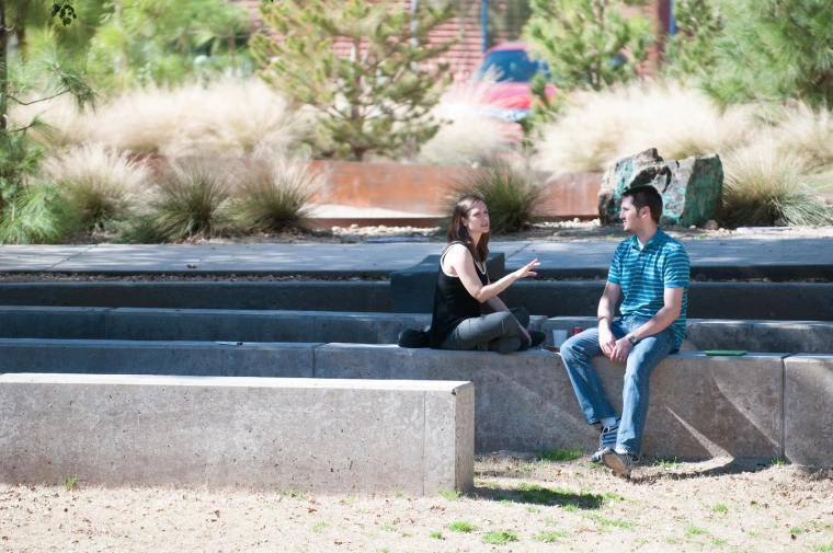 Two students sitting outside