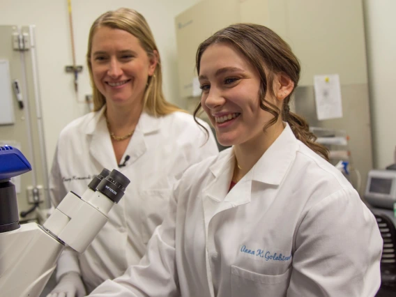  Anna Golebiewski pictured in a lab in front of a microscope