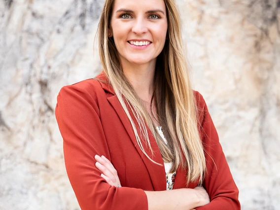 Photograph of Doctor of Nursing Practice (DNP) student Stephanie Gasser in front of a marbled wall