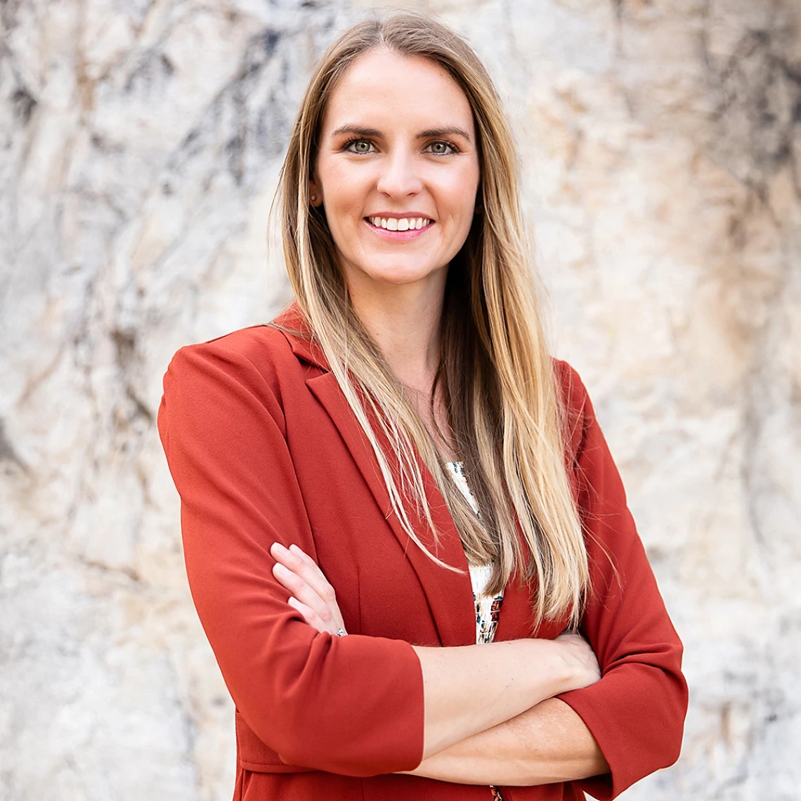 Photograph of Doctor of Nursing Practice (DNP) student Stephanie Gasser in front of a marbled wall